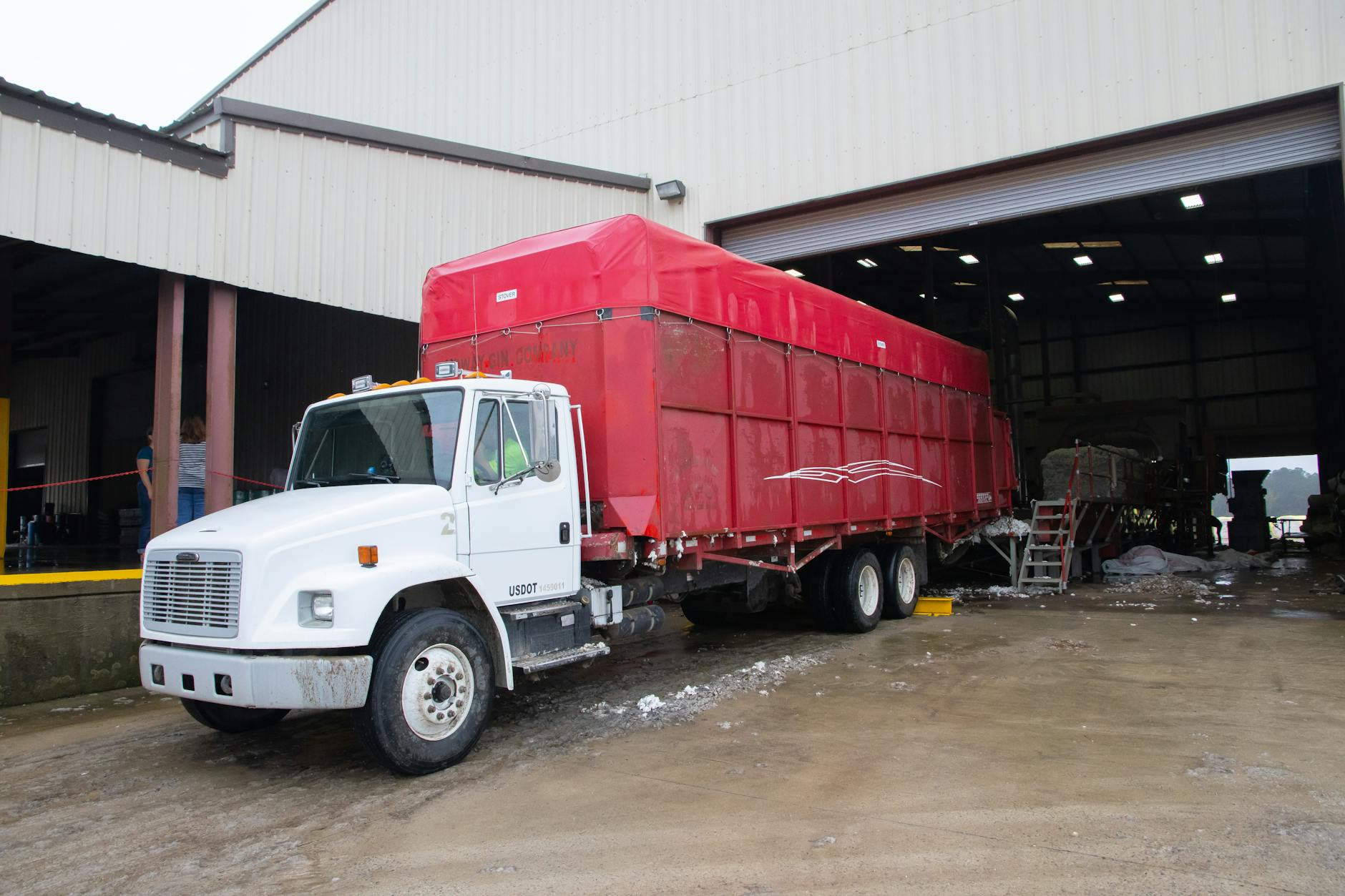 Trucks parked at a warehouse loading dock, illustrating wholesale distribution logistics.