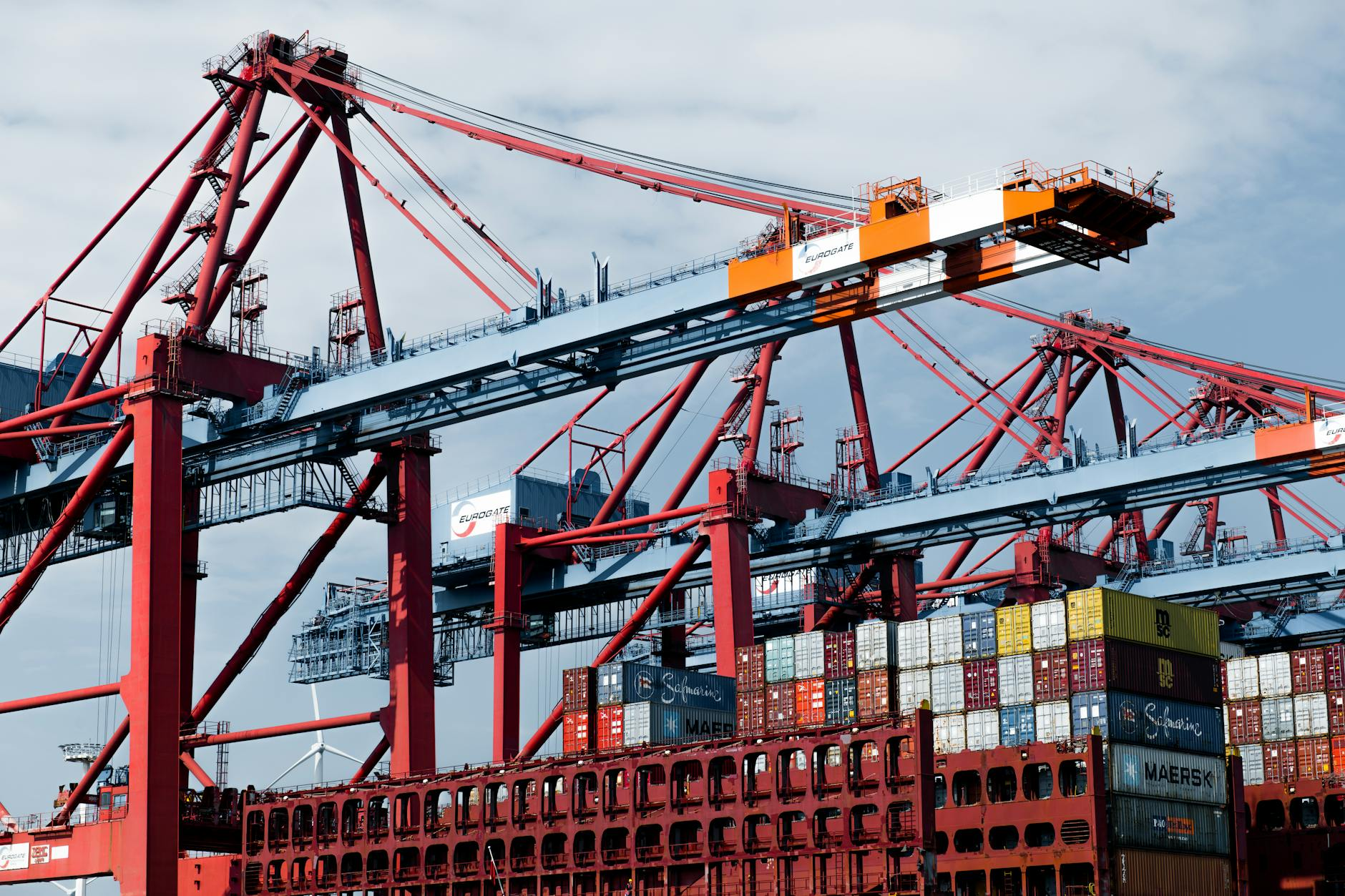 Shipping container crane at an industrial port, illustrating the tariff and nearshoring shifts reshaping wholesale electronics flows.